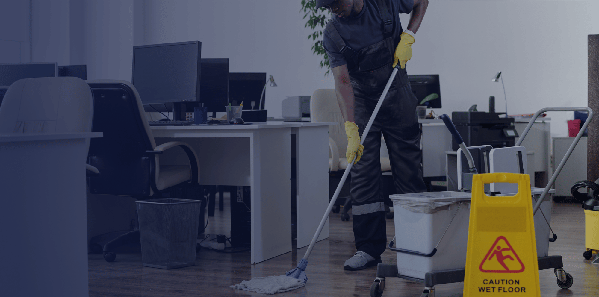 contemporary-young-black-man-workwear-cleaning-floor-openspace-office 1-3