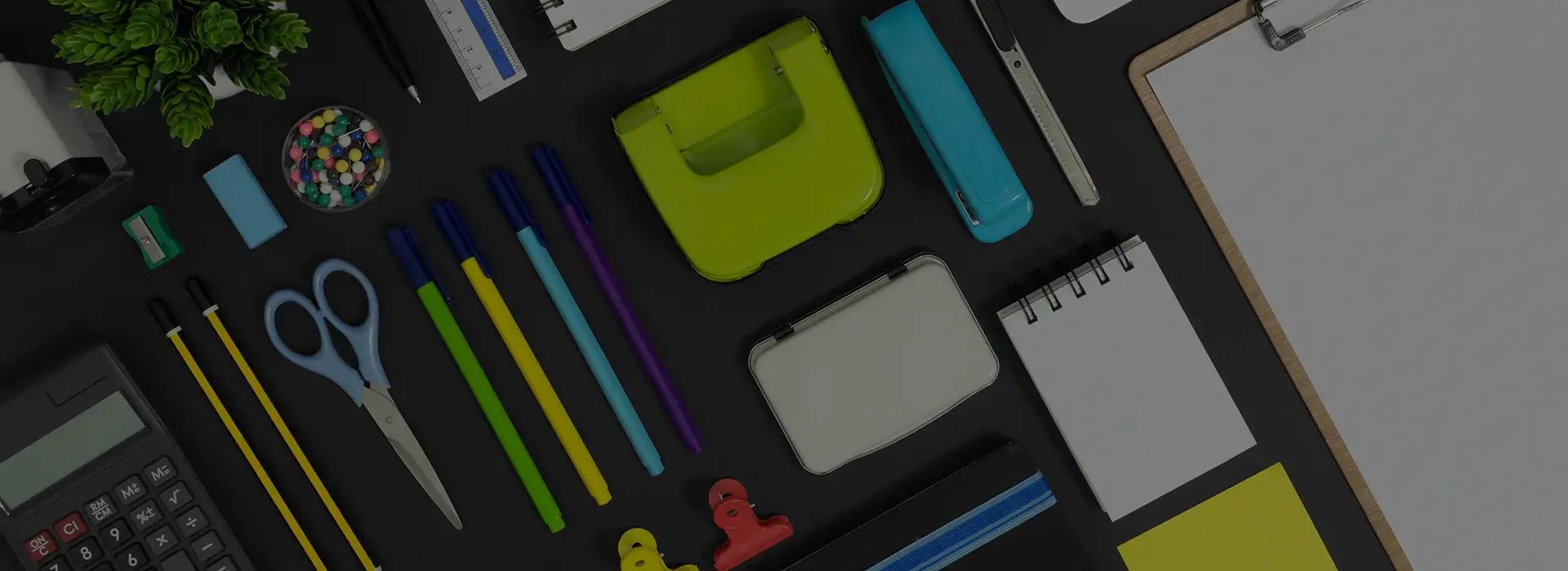 writing utensils and other miscellaneous office supplies on table