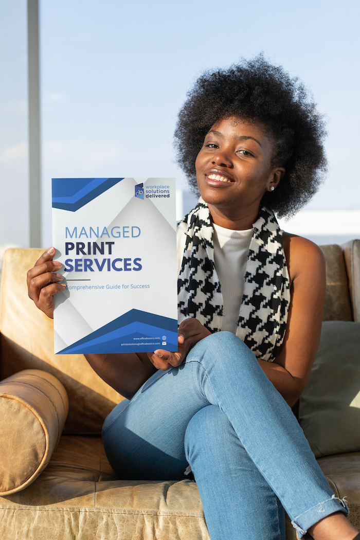 Woman holding the free guide to Managed Print Services